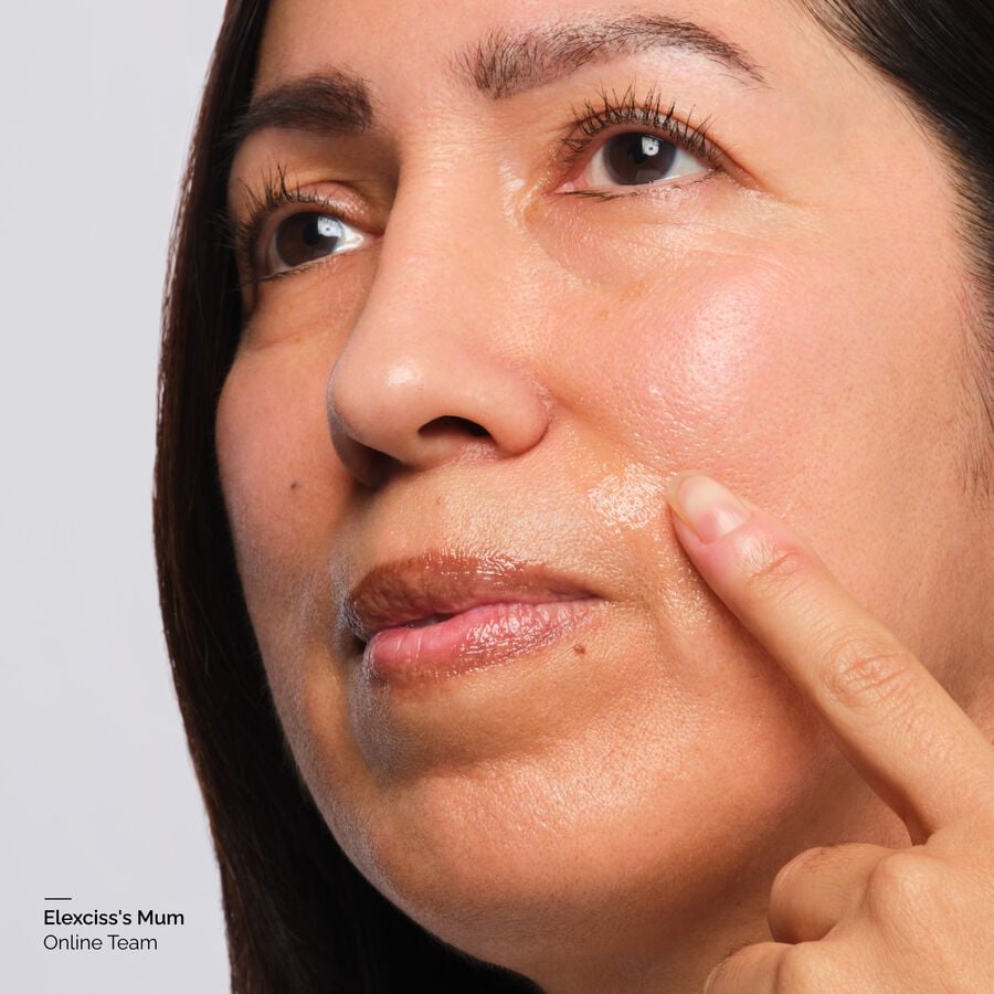 Model applies serum to smile lines